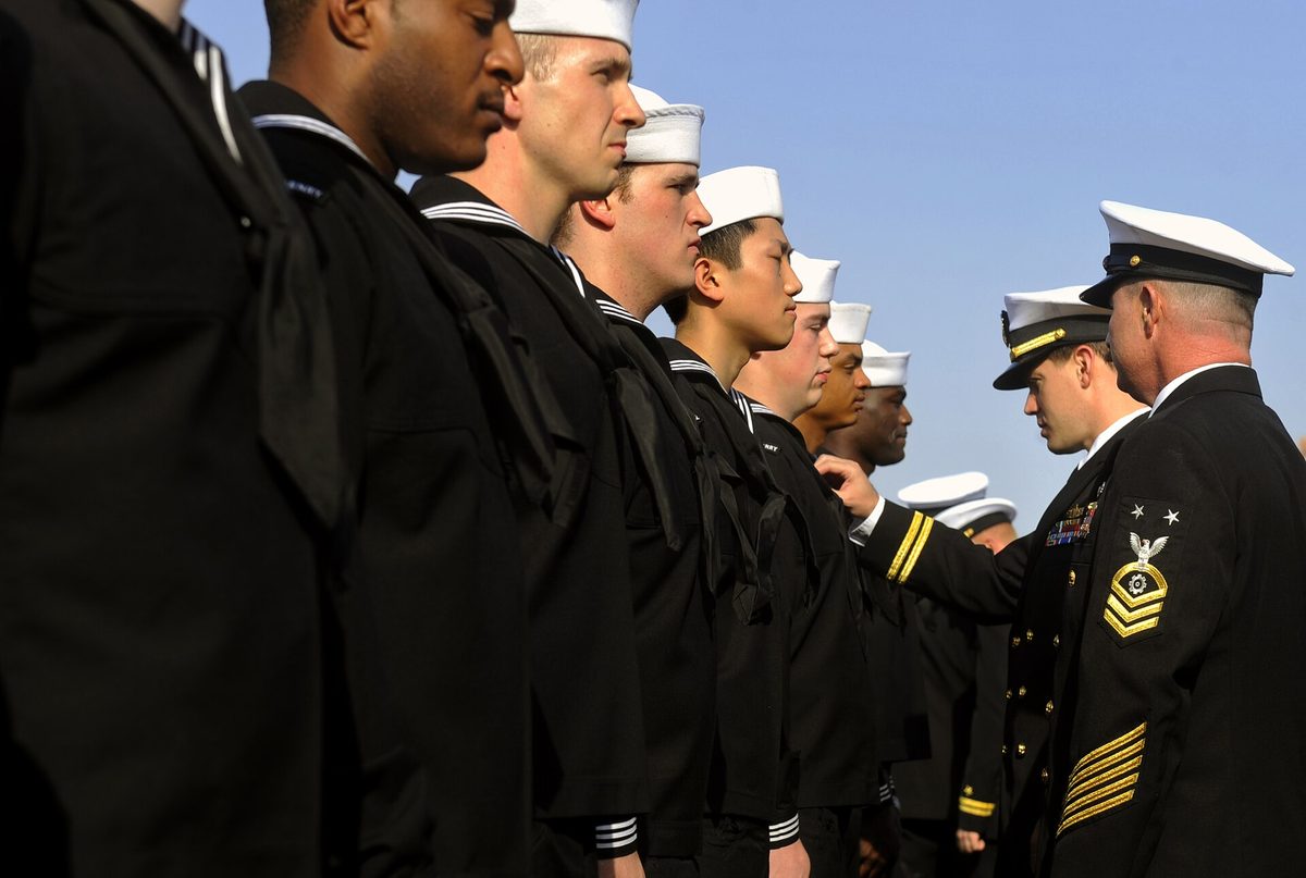 Port of Salalah — US Navy 090925-N-5345W-012 Lt. Christopher Barnes, center, chief engineer, and Master Chief Engineman Billy Strong, engineering department leading chief petty officer, conduct a uniform inspection aboard the amphibious dock lan.jpg